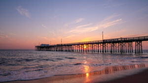 A setting sun behind the long pier, Irvine, Orange County, California